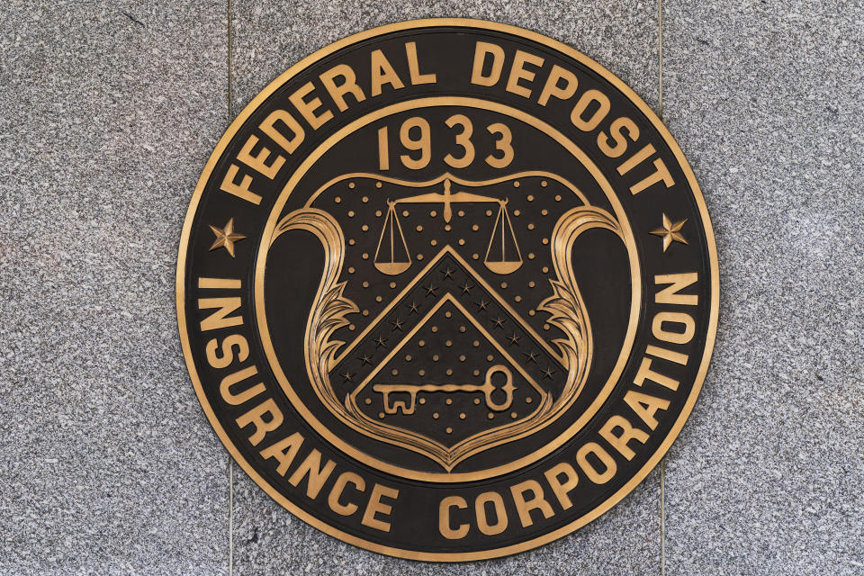 Federal Deposit Insurance Corporation (FDIC) seals are seen outside its headquarters, Tuesday, March 14, 2023. Depositors pulled out savings and investors largely sold off bank stocks as the federal government rushed to reassure Americans that the banking system is safe after two banks. failures. (AP Photo/Manuel Balce Ceneta)